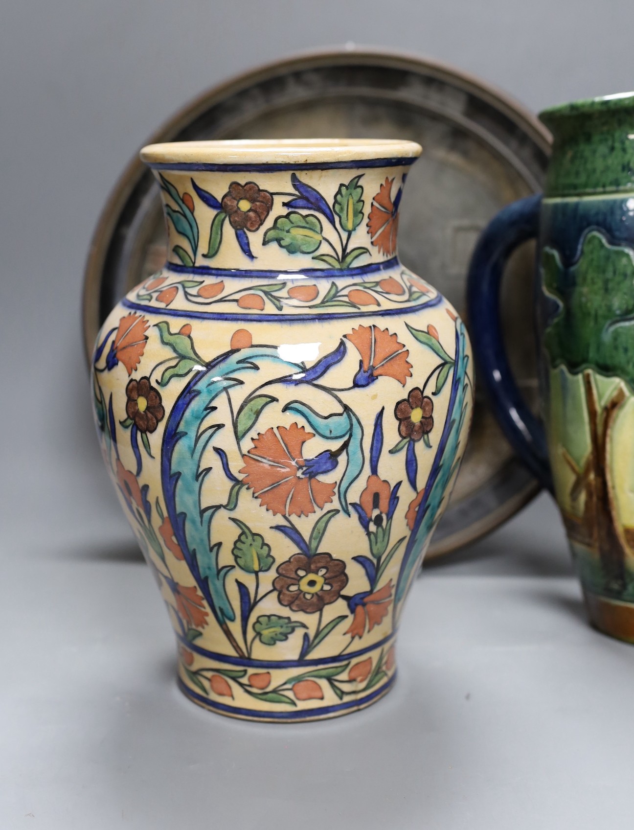 A Dutch jug, a polychrome vase and a Maresch Musterschutz moulded wall plaque, 33 cm diameter